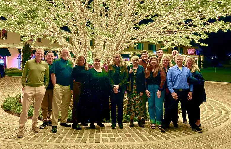 SAS team gathered in Monterey California during December 2025 strategy retreat outside Pebble Beach Lodge holiday tree